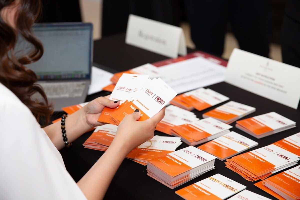 Delegate badges at the registration desk, 1st Doha Arbitration Day